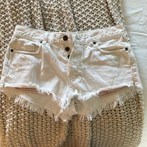 WE THE FREE | distressed cream-colored shorts